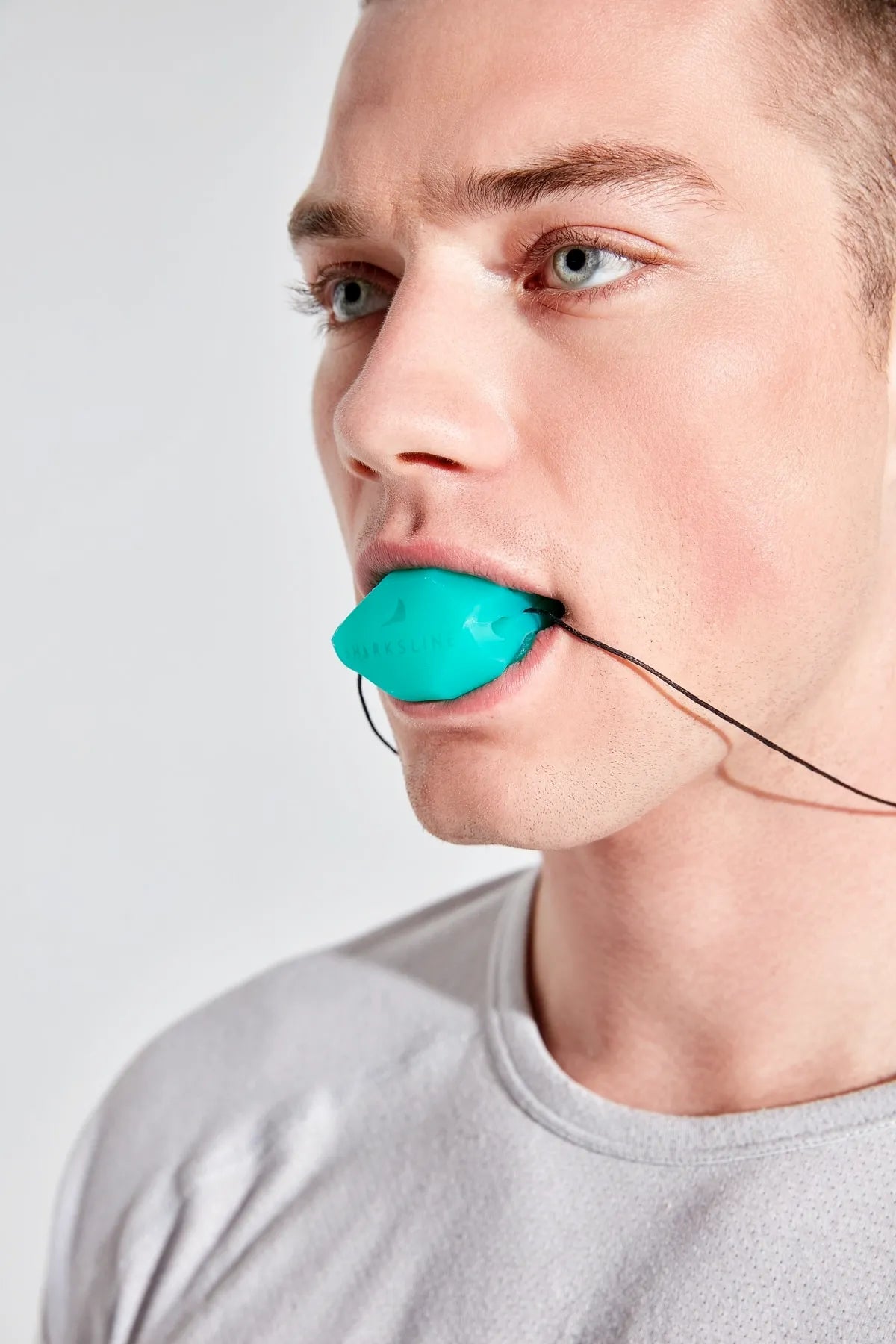biting firmly to shape the pads in front of a mirror